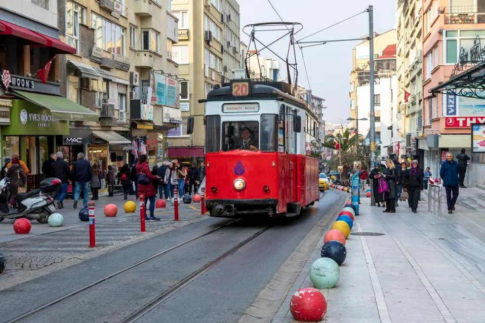 Culinary shot of Kadikoy (kumpir, waffle, or street food selection) or a photo of an alley in Moda with its cafes.