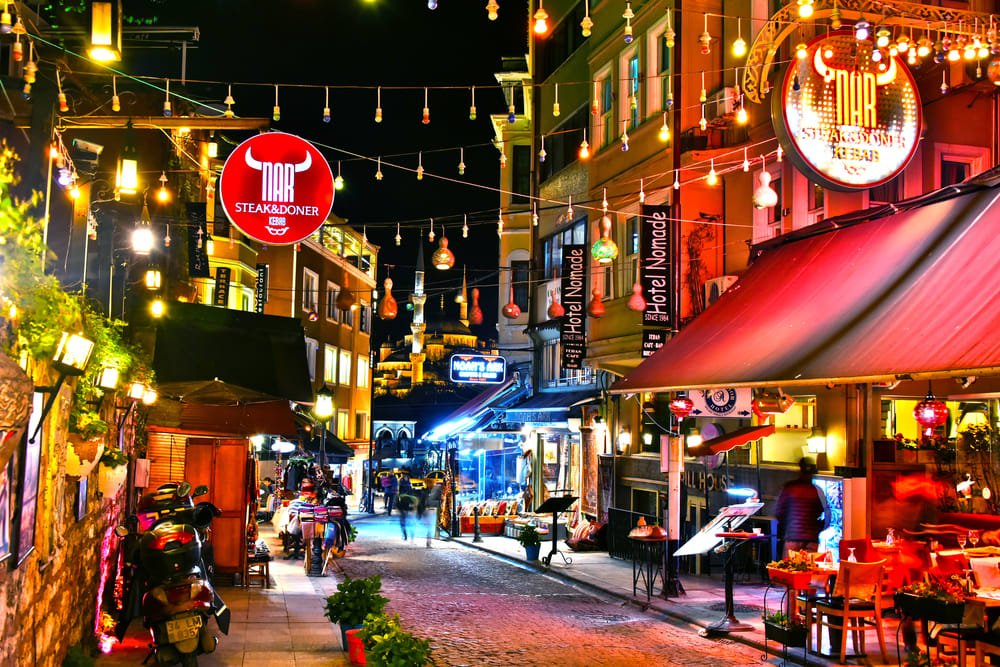 Visual comparison of nightlife in Karakoy (alternative bars) and Beyoglu (crowd on Istiklal at night).