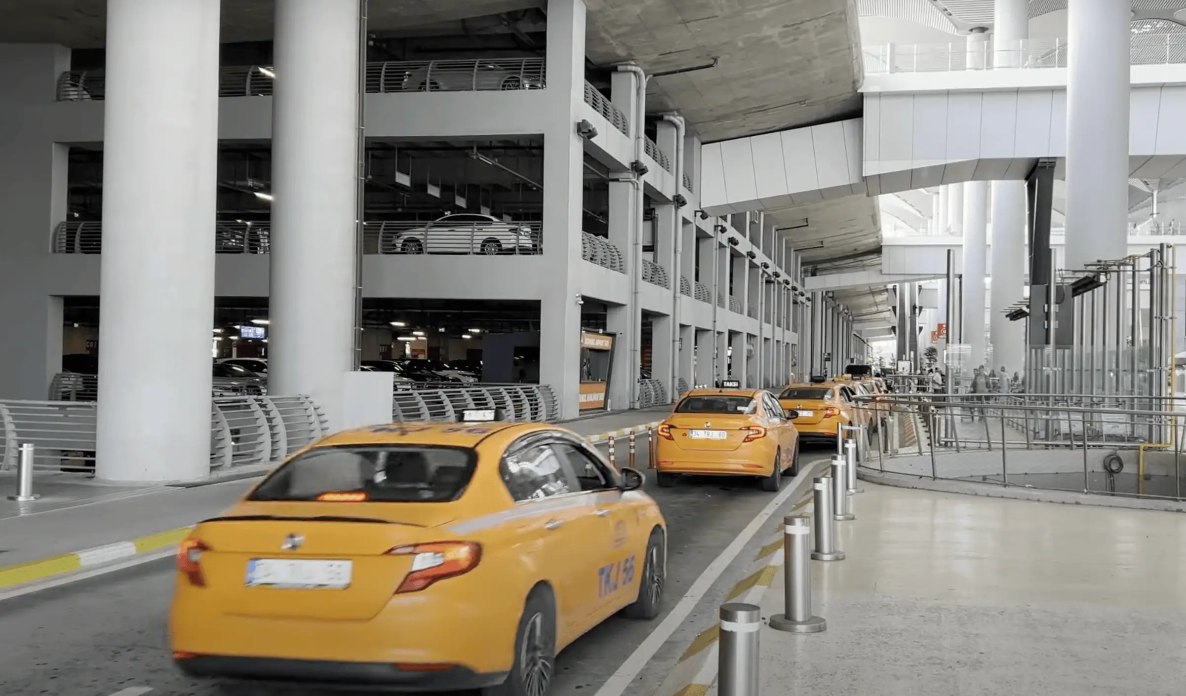 Line of yellow taxis at Istanbul Airport (IST) or ride-hailing vehicle waiting for passengers.