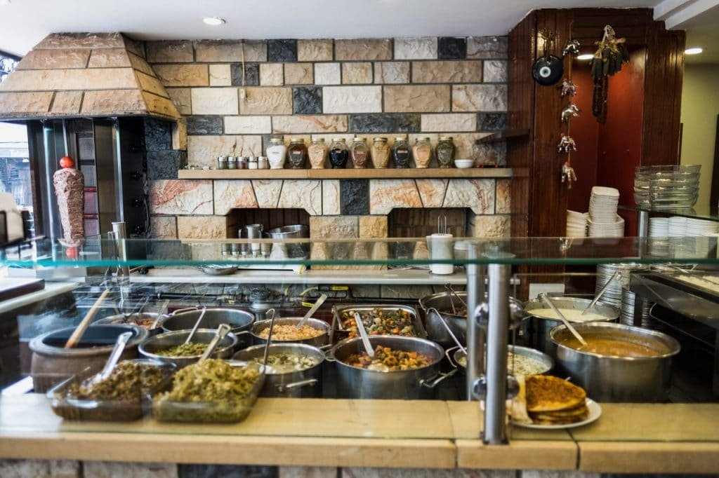 An assortment of Turkish street food, including a colorful kumpir and generously topped waffles, or a table with various Turkish mezzes.
