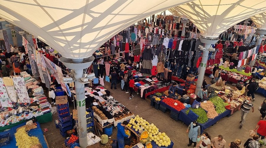Lively scene of Kadıköy Market with colorful stalls and passersby
