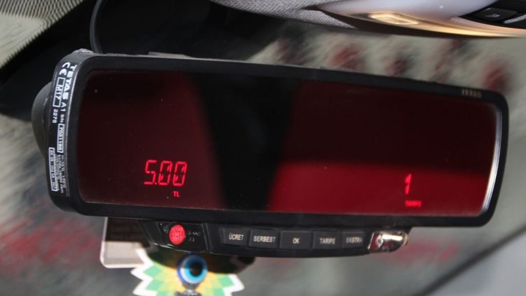 Interior of a Turkish taxi showing the taximeter turned on, or passengers showing the use of a ride-hailing app.
