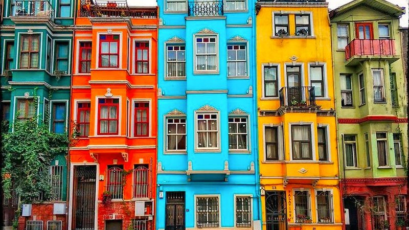 View of the famous Merdivenli Yokuşu street in Balat with its colorful houses, or a photo of the imposing Phanar Greek Orthodox College.