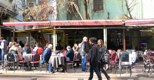 Interior of a trendy Cihangir cafe with people reading or chatting.