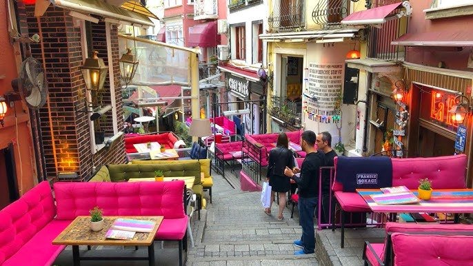 Typical cobblestone street in Cihangir with cafes on the terrace and a bohemian atmosphere.